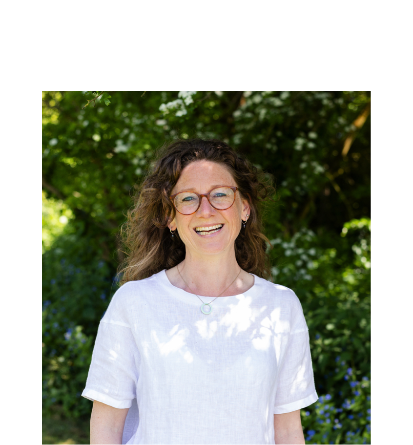 Harriet PIlkington sits on a grey couch while smiling, wearing a black t-shirt and blue jeans. Script text reads: “Build better relationships.”